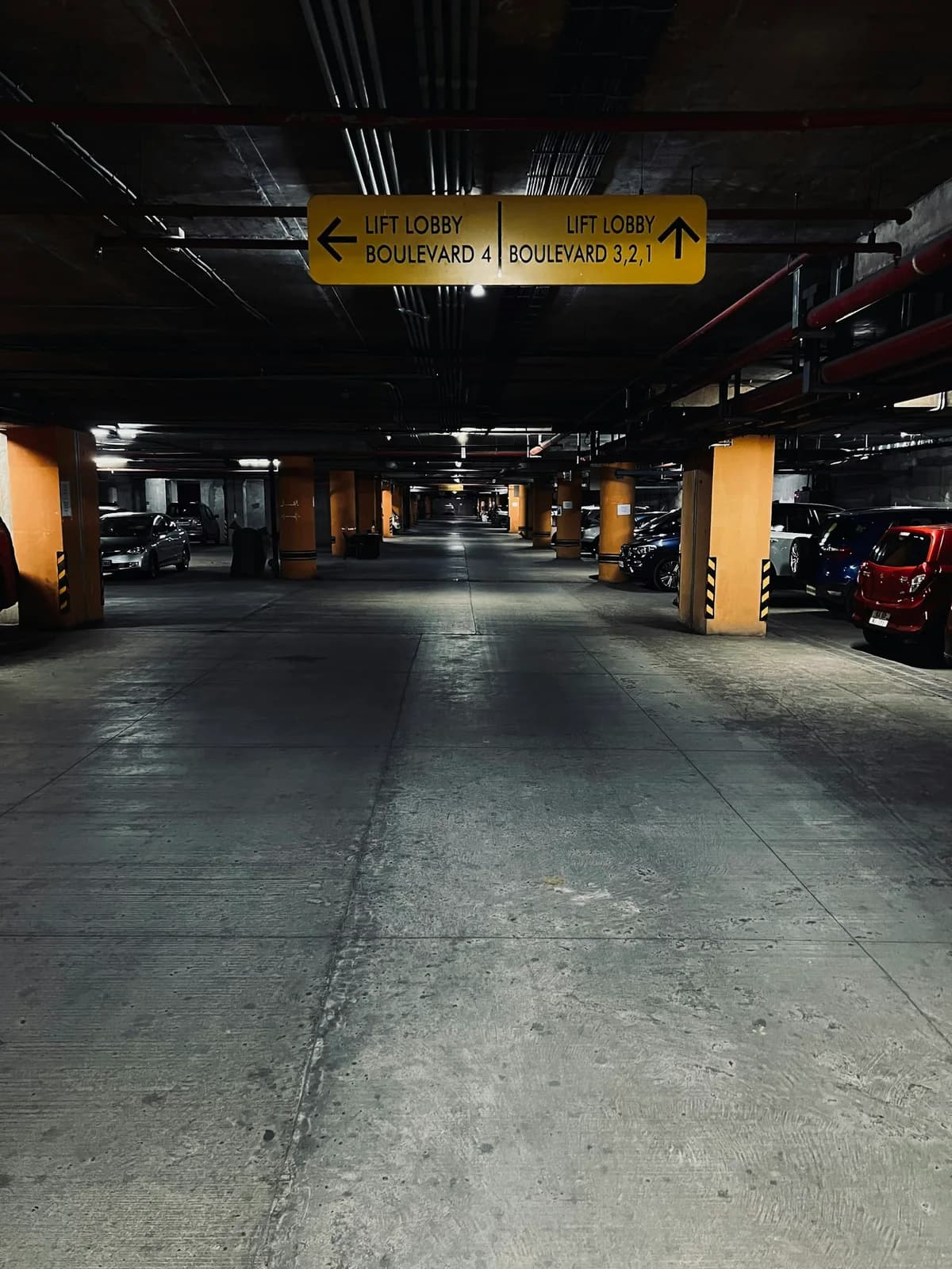 Cars parked beside a shared access aisle in a residential garage