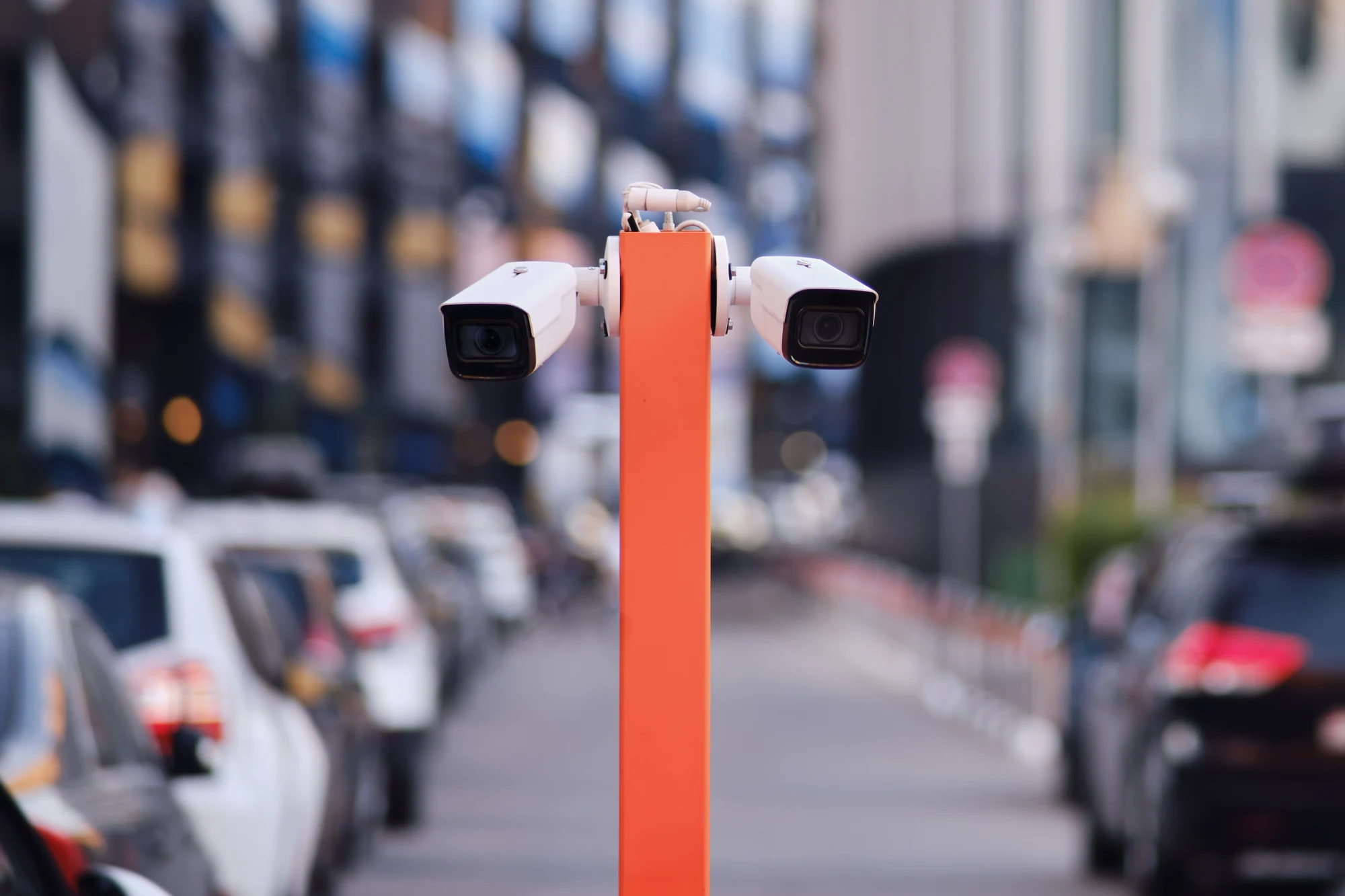Two vehicle entrance cameras mounted beside a traffic lane
