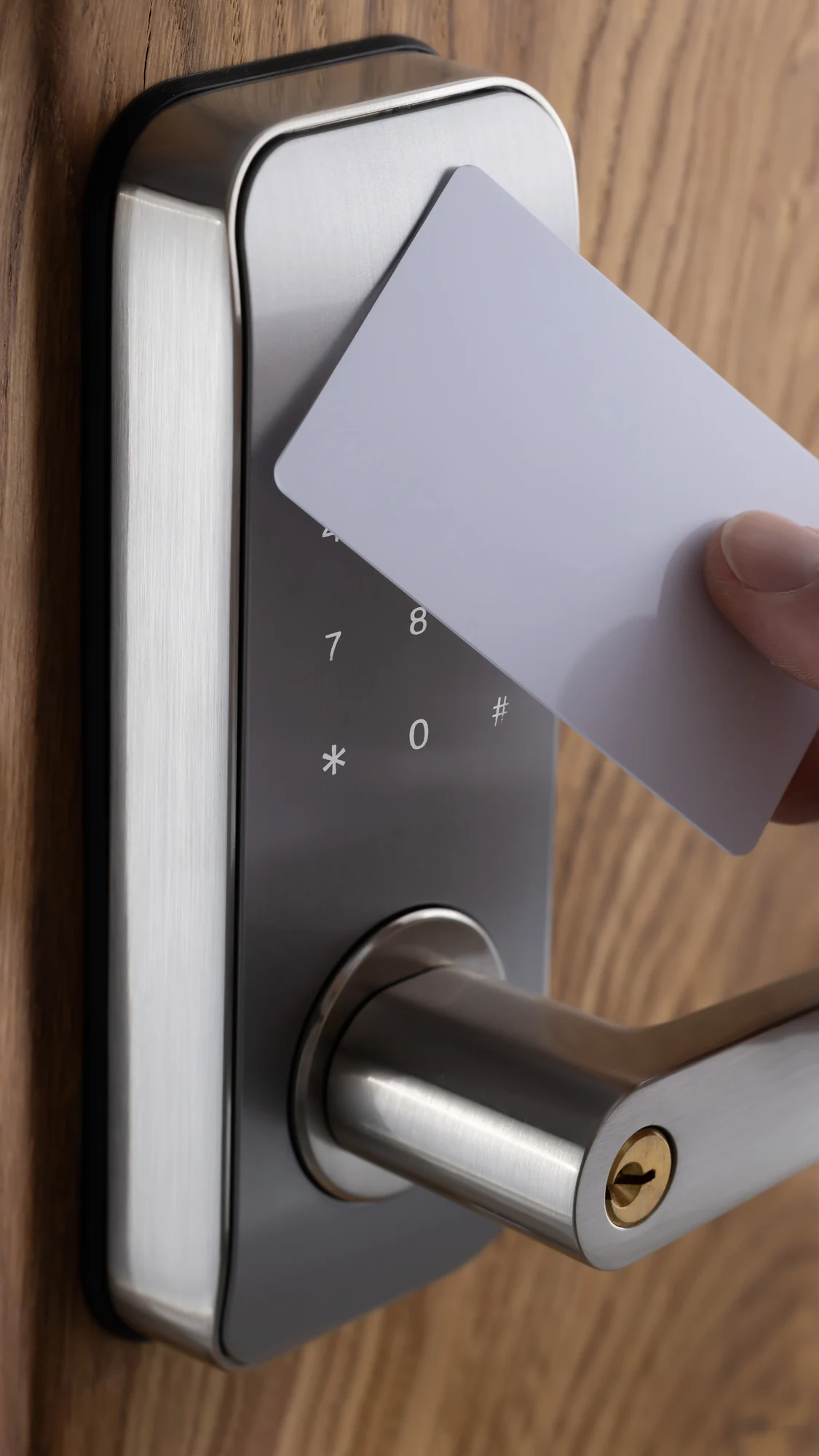 RFID card held against an electronic door lock with an integrated keypad