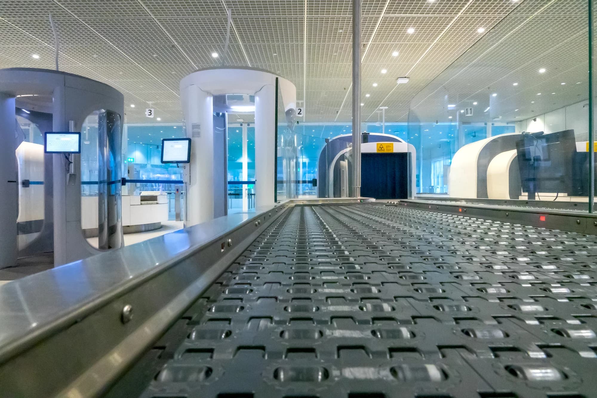 Conveyor leading into a baggage scanner at a security checkpoint