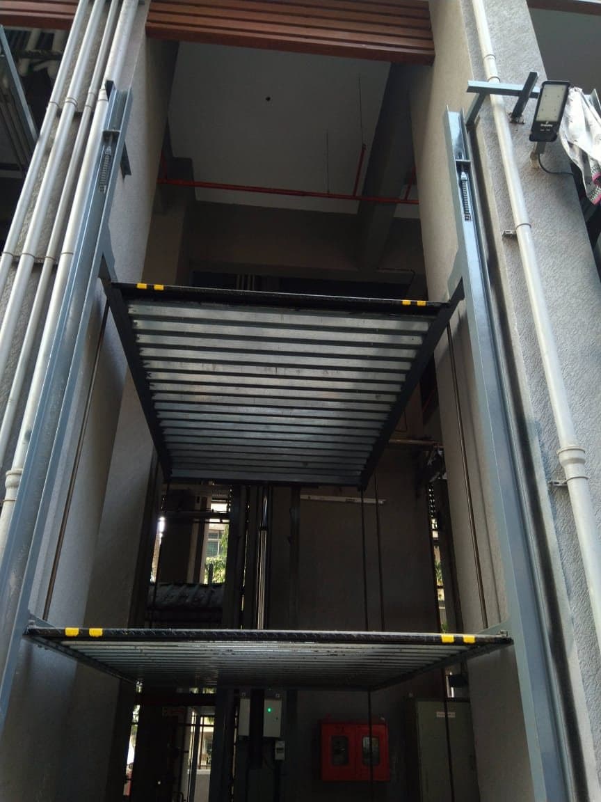Vertical lift stack with two galvanised platforms between building columns