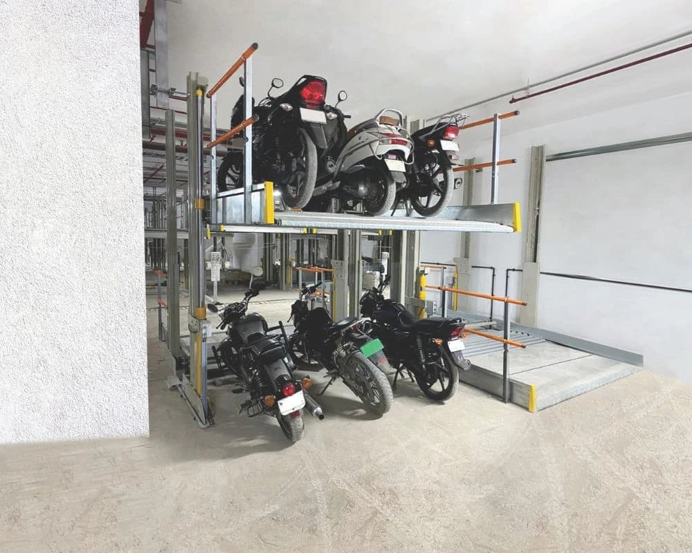 Motorcycles stored on ground-level and raised parking platforms